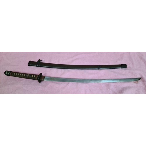 228 - A Japanese WWII officer's katana, signed tang, cast tsuba, cotton bound shark skin grip, metal scabb... 