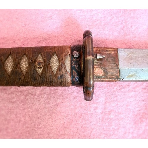 228 - A Japanese WWII officer's katana, signed tang, cast tsuba, cotton bound shark skin grip, metal scabb... 