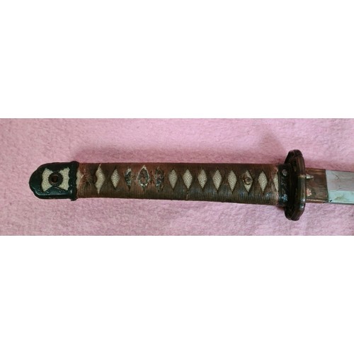 228 - A Japanese WWII officer's katana, signed tang, cast tsuba, cotton bound shark skin grip, metal scabb... 