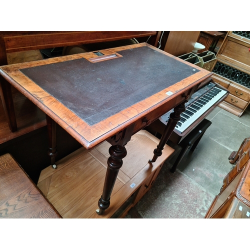 A Victorian walnut writing table, width 99cm.
