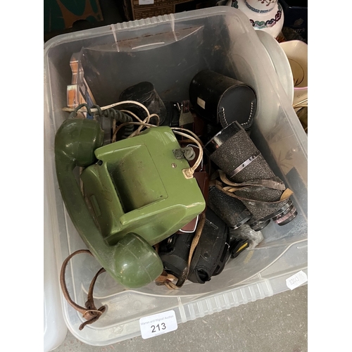 213 - A box of cameras and related items, binoculars, lenses, etc and a vintage telephone.