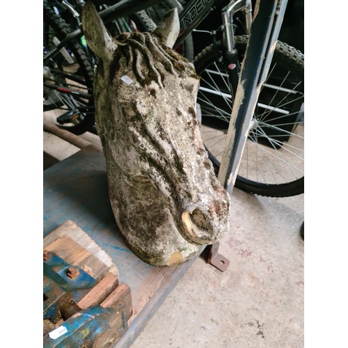 1037 - A horses head concrete garden ornament, height 53cm. 
Condition- signs of age including wear and som... 