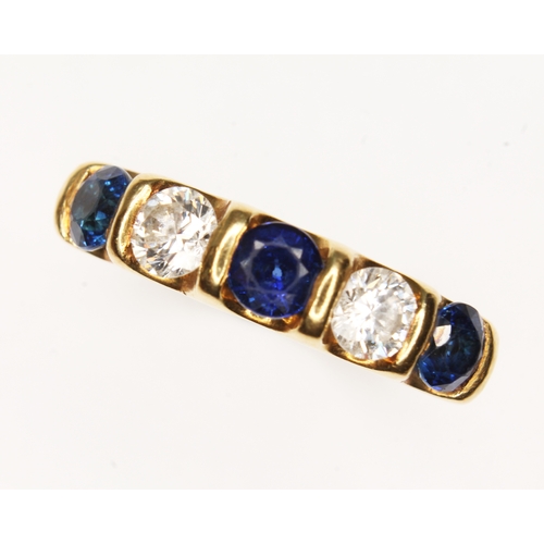 119 - A diamond and sapphire baguette ring, three round cut sapphires weighing approx. 1ct in total, inter... 