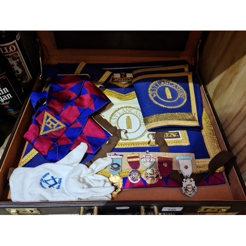 148 - A case of Masonic regalia including medals