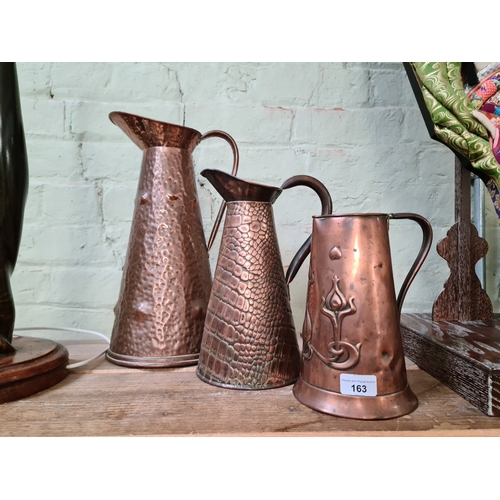 163 - Three Arts & Crafts copper jugs, one by Joseph Sankey & Son.