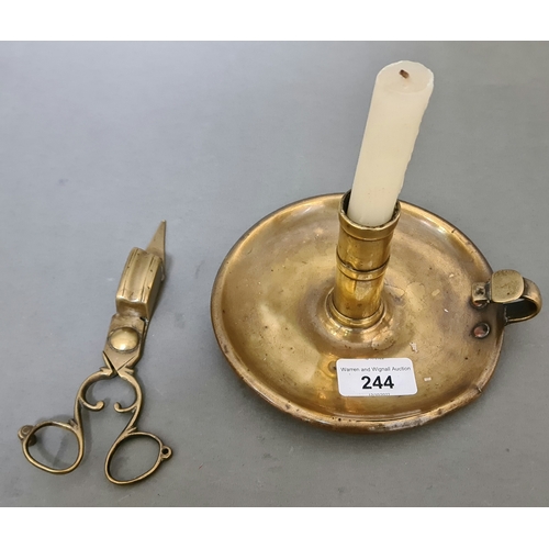 244 - An early 19th century brass candlestick and snuffer.