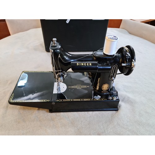 150 - A circa 1950s - 1960s Singer Featherweight portable electric sewing machine, model 221K, with access... 