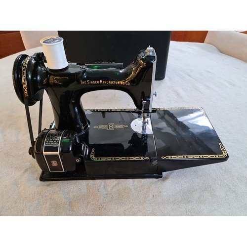 150 - A circa 1950s - 1960s Singer Featherweight portable electric sewing machine, model 221K, with access... 