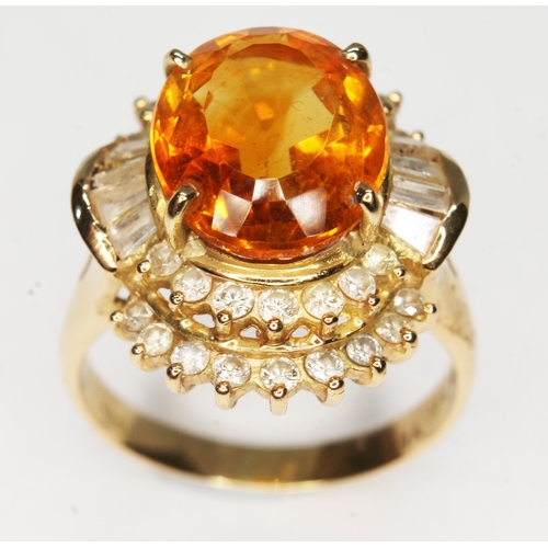 165 - A citrine and diamond ballerina cluster ring, the central oval mixed cut stone weighing approx. 4.60... 