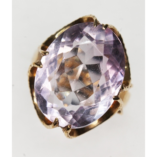 192 - A hallmarked 9ct gold ring set with an oval mixed cut amethyst weighing approx. 8ct, gross wt. 5g, s... 