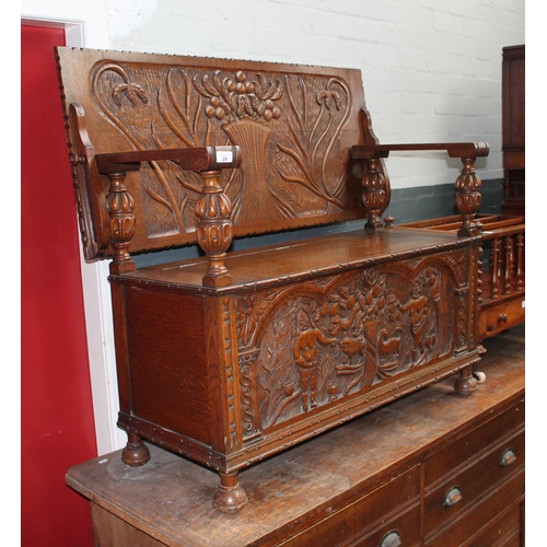 24 - A 20th century carved oak monk's bench, length 118cm.