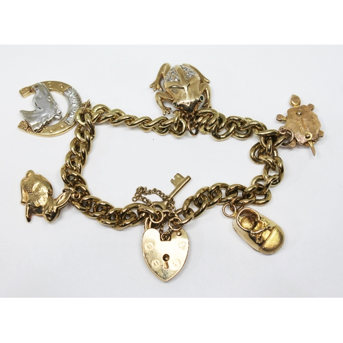 288 - A hallmarked 9ct gold charm bracelet, gross wt. 34.4g.