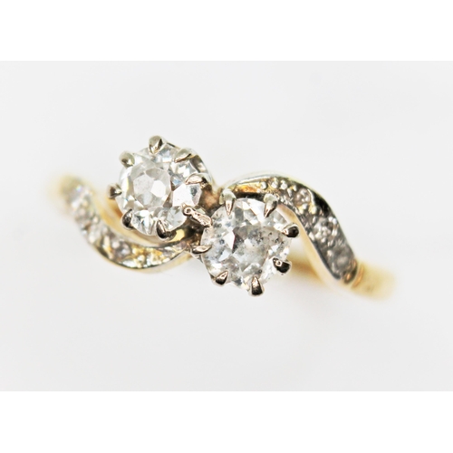 57 - A diamond crossover ring, the two old Eurpoean cut diamonds weighing approx. 0.30 carats each, colou... 