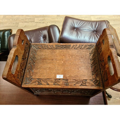 7 - An Art & Crafts carved oak box stool, height 56cm and width 51cm.