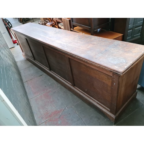 23 - A large early 20th century oak shop counter, originally from a millinery shop in Crosby, height 90.5... 