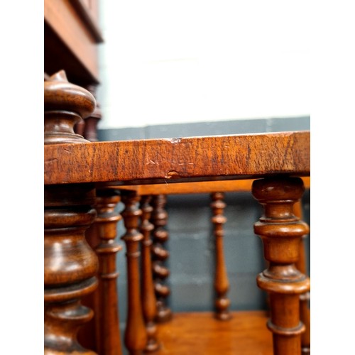 25 - A Victorian walnut Canterbury with twist supports.