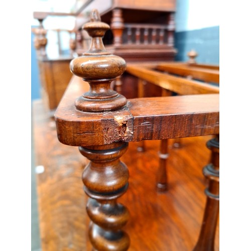 25 - A Victorian walnut Canterbury with twist supports.