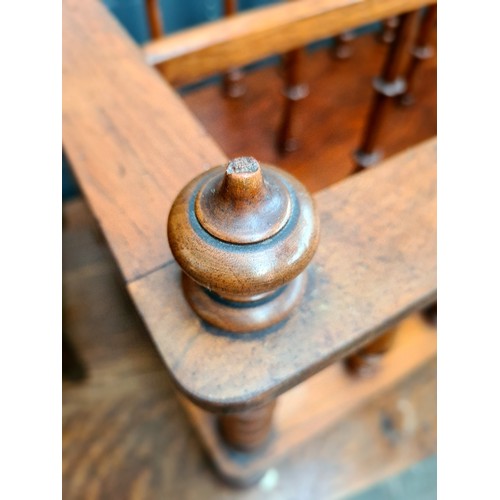 25 - A Victorian walnut Canterbury with twist supports.