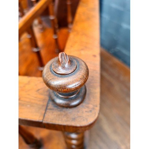 25 - A Victorian walnut Canterbury with twist supports.