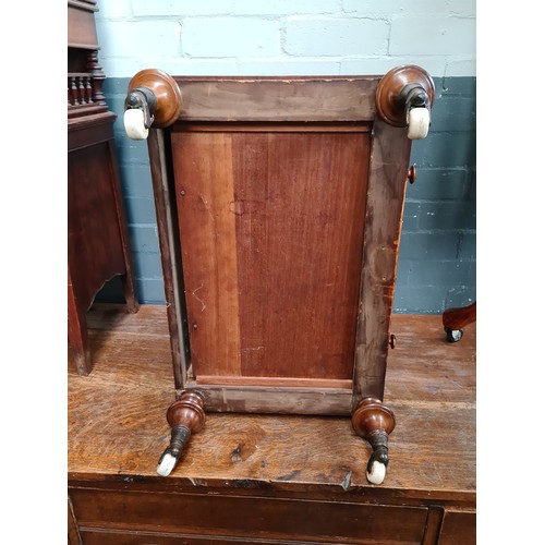 25 - A Victorian walnut Canterbury with twist supports.