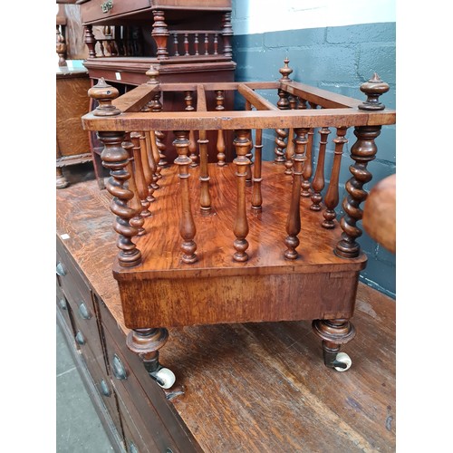 25 - A Victorian walnut Canterbury with twist supports.