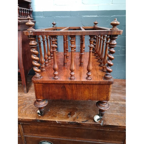 25 - A Victorian walnut Canterbury with twist supports.