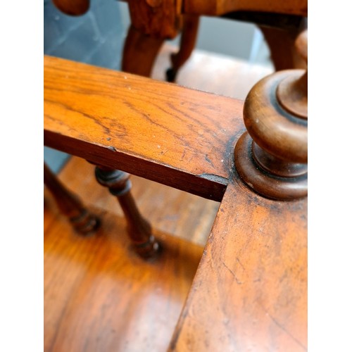 25 - A Victorian walnut Canterbury with twist supports.