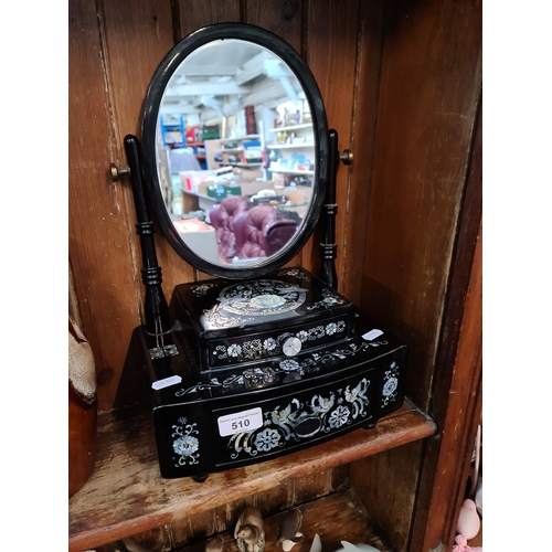 510 - An modern black lacquer and mother of pearl dressing table mirror.