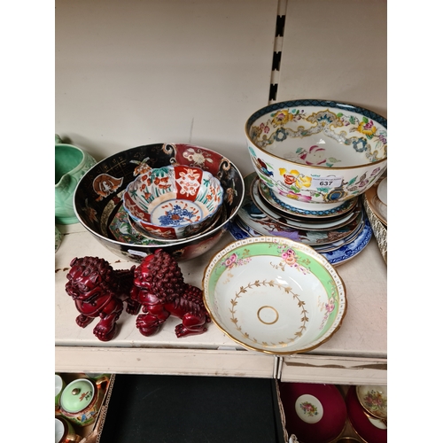 637 - A collection of various items of Chinese pottery including plates, bowls and a pair of lion dogs.