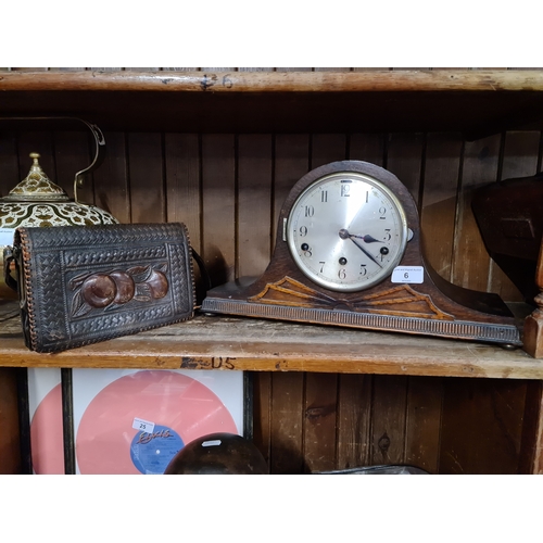 6 - An embossed leather hand bag and a chiming mantle clock .