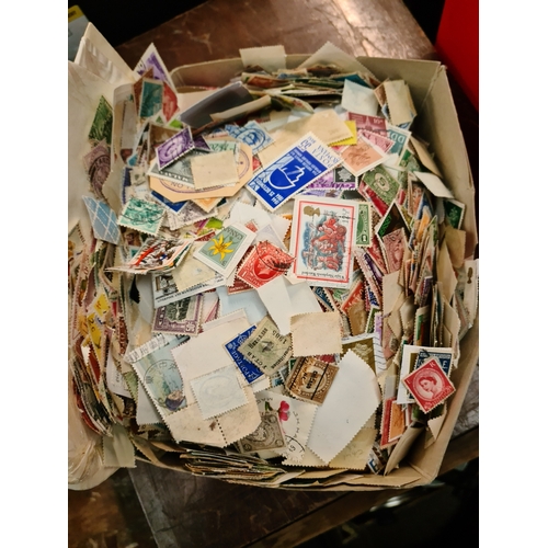 61 - A bag of loose stamps.