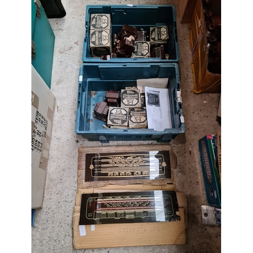 362 - A box of vintage Telsen radio transformers, 23 plus condensers and four radio station glasses.