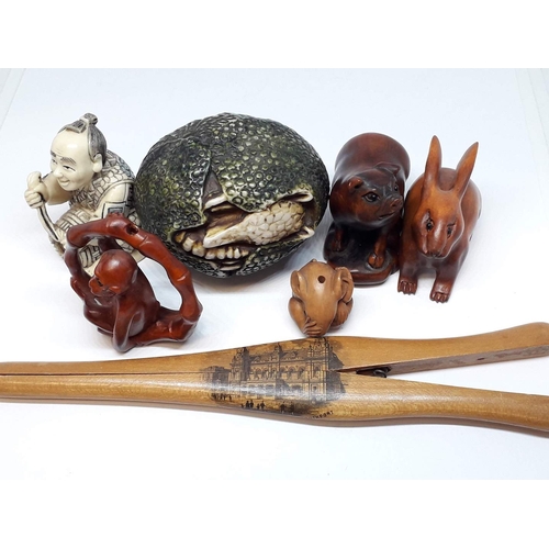 103 - A group of oriental hardwood and resin carvings, together with a a pair of Mauchline ware glove stre... 