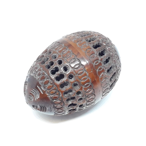 114 - A pierced and carved coquilla nut.