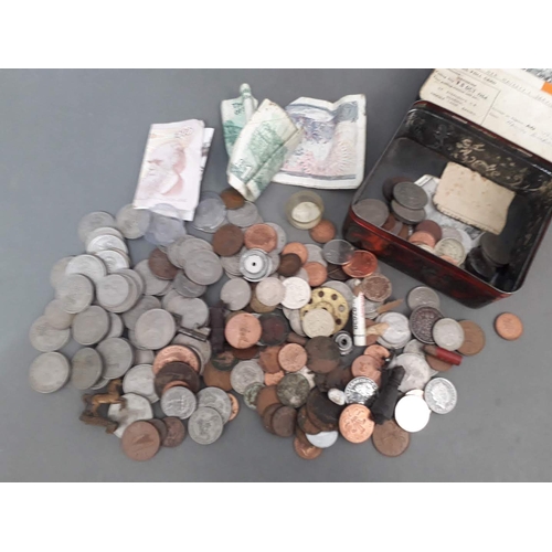 208 - A tin of assorted coins and notes.