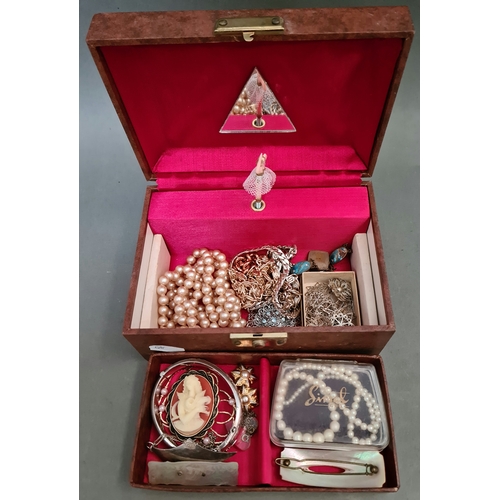 50 - A musical jewellery box containing a variety of costume jewellery to include silver, a string of nat... 