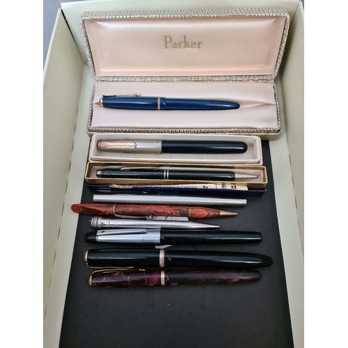 63 - A collection of pens, fountain pens to include Parker,  3 with 14ct nibs, a silver plated pen, etc.