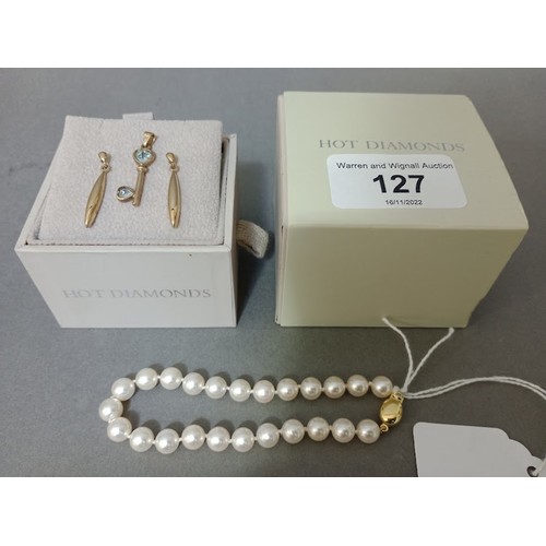 127 - A pair of yellow metal earrings together with a pendant in shape of key, marked 375 and a pearls bra... 