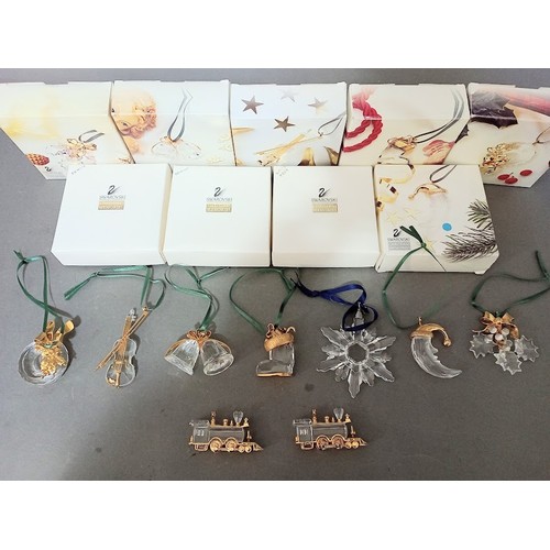 150 - Nine Swarovski crystal christmas ornaments, all with boxes.