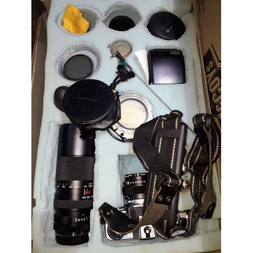 318 - An Olympus OM10 with five lenses and accessories.