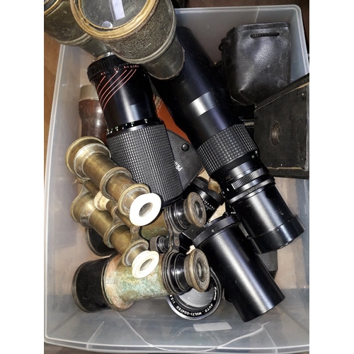 320 - A box of assorted camera lenses and opera glasses.