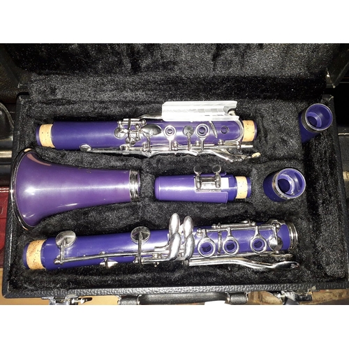 277 - A Virtuosi purple clarinet with hard case.