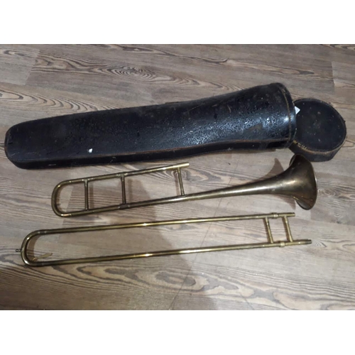 294 - A vintage Couesnon trombone in case.