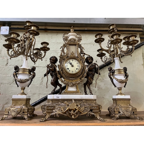 164 - A brass and marble Imperial Brevattato mantel clock with candelabra garniture, height 25inches.