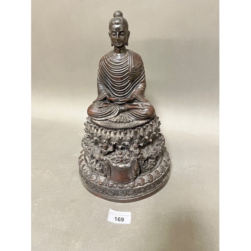 169 - A vintage ornate Buddha statue on plinth.