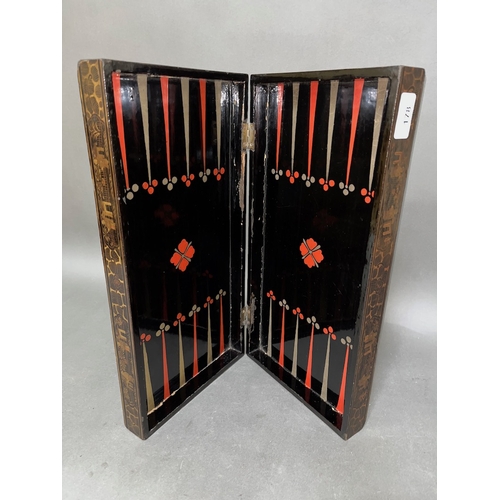 178 - A Chinese lacquer folding chessboard.