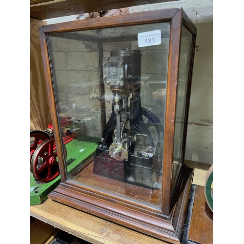 181 - A Stuart Turner vertical steam engine, height 34cm, housed within glass display case.