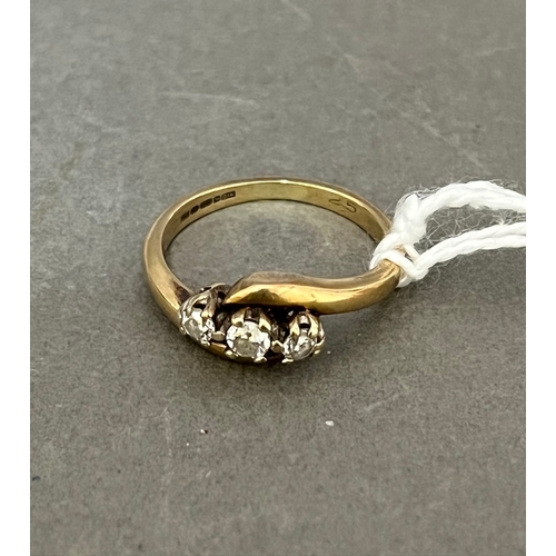 234 - A 9ct gold three stone diamond ring.