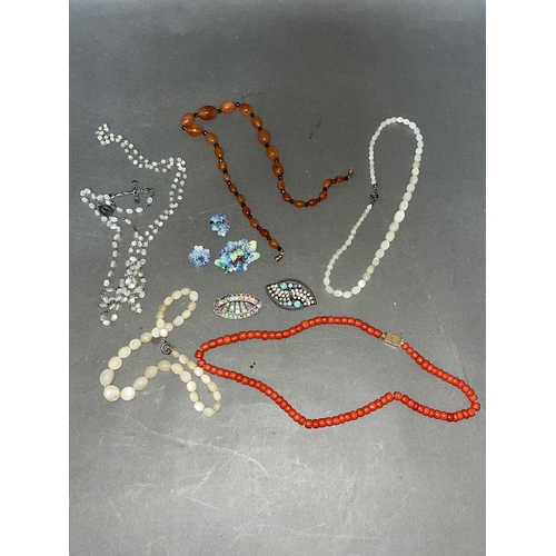 236 - A mixed lot of costume jewellery comprising coral, mother of pearl and carnelian beads.