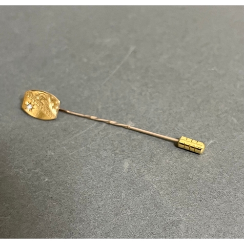 240 - A hallmarked 9ct gold diamond stick pin, wt. 1g.